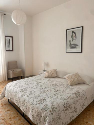a bedroom with a bed in a white room at La casa di Michelle in Foggia