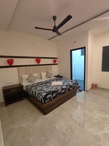 a bedroom with a bed and a ceiling fan at Hotel Crown Plaza in Jalandhar