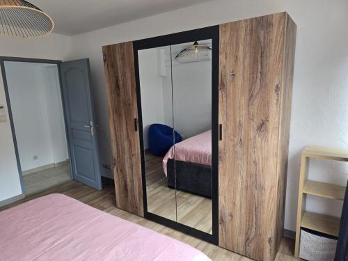 a bedroom with a glass door with a bed at Le Flavida brilliant in Saint-Louis