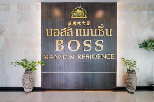 a sign for a muslim boss in a building at Boss Mansion in Bangkok