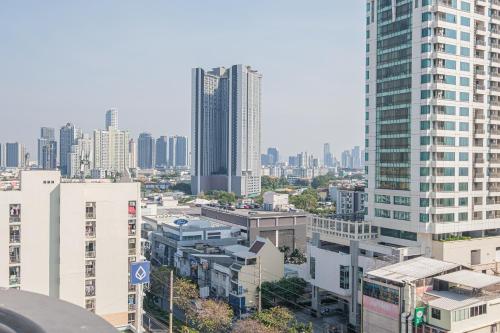 an aerial view of a city with tall buildings at Boss Mansion in Bangkok