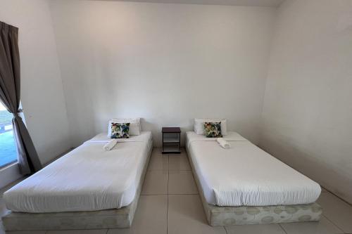 Ένα ή περισσότερα κρεβάτια σε δωμάτιο στο Jasa Resort Sungai Lembing