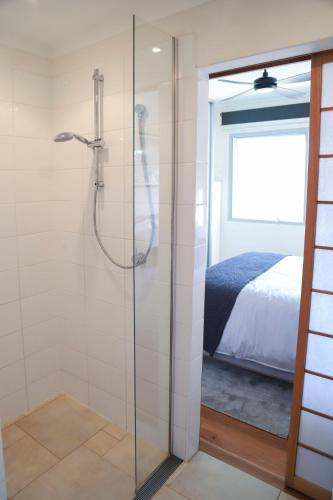 a glass shower in a bedroom with a bed at Ellen City Centre in Fremantle
