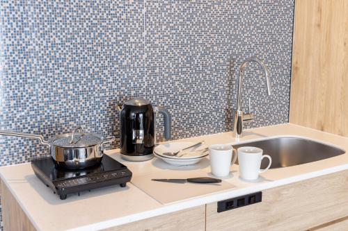a kitchen counter with a mixer and a sink at Tokyu Stay Gotanda in Tokyo