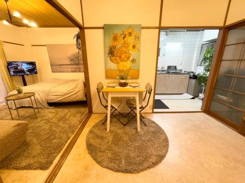 a room with a table with a vase of flowers on it at Best Shinjuku Modern Full-furnished Family size Apartment5 ONLY 2min to Shinjuku by Train in Tokyo