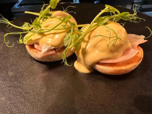 two sandwiches with meat and cheese on a table at The Airds Hotel and Restaurant in Port Appin