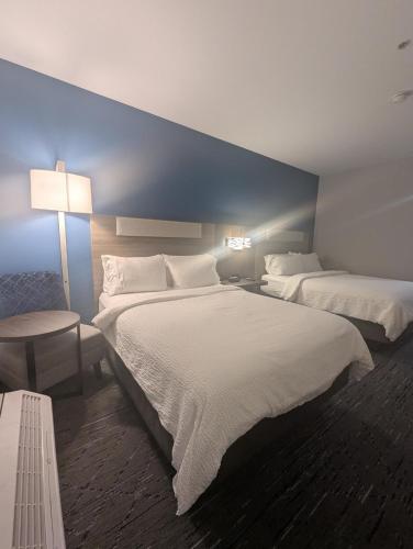 a bedroom with two beds and a blue wall at Holiday Inn Express Hotel & Suites Loveland by IHG in Loveland