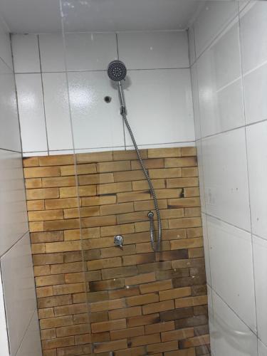 a shower with a hose attached to a brick wall at Pousada Alameda Boa Vista in Recife