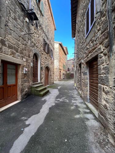 an empty alley between two stone buildings at Borgo House in Abbadia San Salvatore