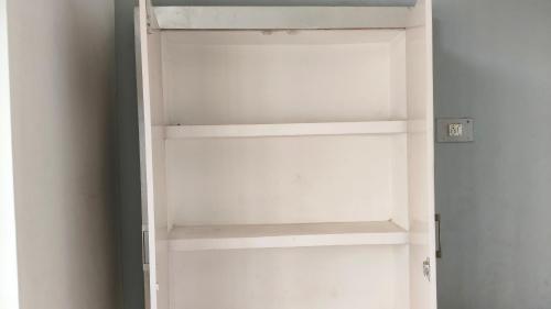 a white book shelf in a room at Vimla Homestay in Faizābād