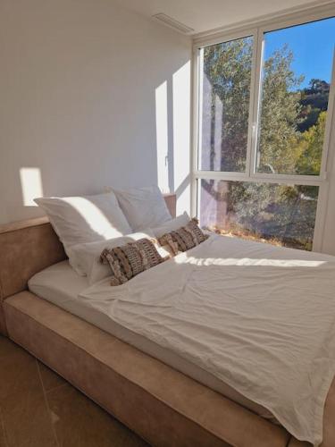 a bed in a room with a large window at Noahs Paradise in Benissa
