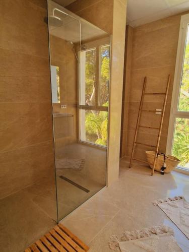 a shower with a glass door in a bathroom at Noahs Paradise in Benissa