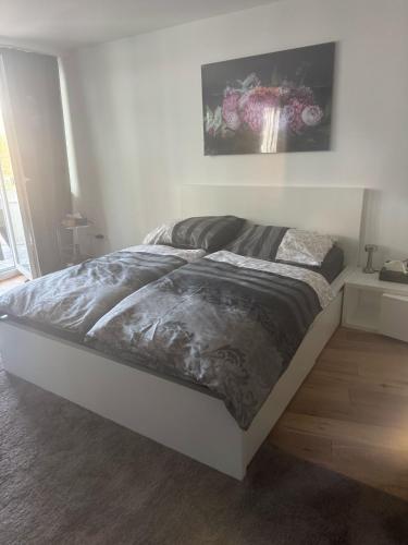 a bed in a white room with at Stuttgart mitte in Stuttgart