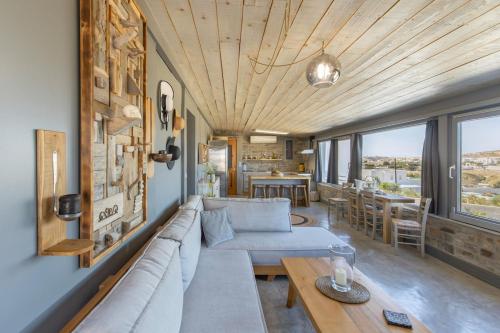 a living room with a couch and a table at Vitamine Sea House - Island Living Paros in Parasporos