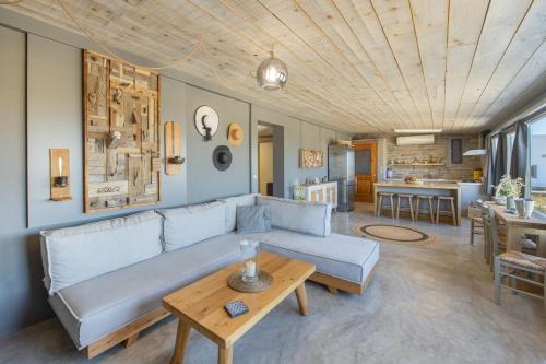 a living room with a couch and a table at Vitamine Sea House - Island Living Paros in Parasporos