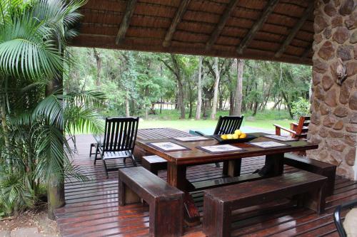 a wooden table and chairs on a wooden deck at House On Blyde in Kampersrus AH