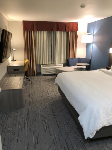 a hotel room with a bed and a desk at Holiday Inn Express Hotel & Suites Loveland by IHG in Loveland