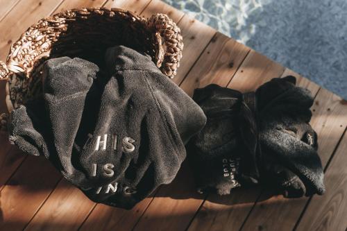 a pair of gloves sitting on top of a wooden table at Jufenalm BOHO & Wellnesshotel in Maria Alm am Steinernen Meer