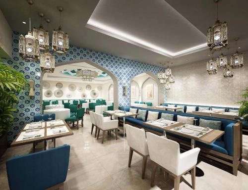 a restaurant with blue walls and tables and chairs at Vacay Lettings 2 Bed Retreat near Burj Al Arab in Dubai