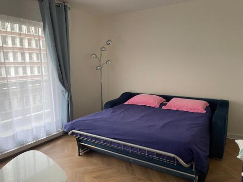 - une chambre avec un lit et 2 oreillers roses dans l'établissement Large studio apartment Invalides Montparnasse, à Paris