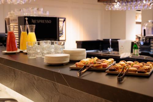 two trays of food on a counter in a restaurant at Pillows City Hotel Brussels Centre in Brussels