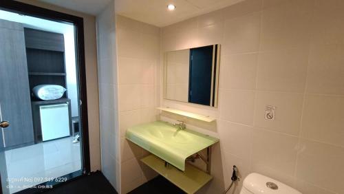 a bathroom with a green sink and a mirror at Bay Shore Ocean View by Get A Rent Phuket in Patong Beach