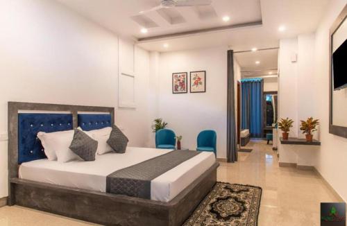 a bedroom with a bed and chairs in a room at The Cloudberry Kasauli I Guaranteed Best Price I Serviced Villa I Open Air Rooftop I Couple Friendly I Pvt Balcony I Kasauli By ExoticStays in Kasauli