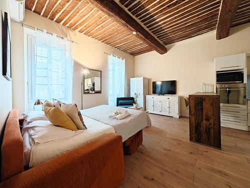 a bedroom with a bed and a couch in a room at Croisette carre d'or in Cannes