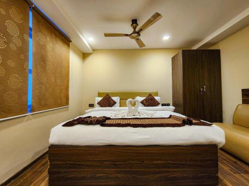 a bedroom with a large bed with a ceiling fan at Arcadian Hotel in Gangtok