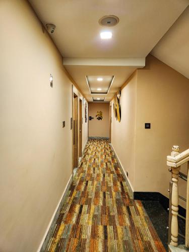 an empty hallway with a rug on the floor at Arcadian Hotel in Gangtok