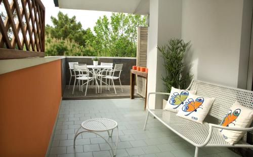 a balcony with a table and chairs on a patio at Hotel Eros Residence in Cervia