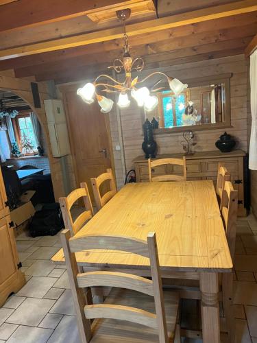 a dining room with a wooden table and chairs at Panoramic Bungalow Sint Gillis-Waas in Sint-Gillis-Waas