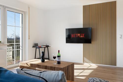 a living room with a tv on a wall at DREAMLEAF - LUXURY - NATURE - free parking in Günzburg