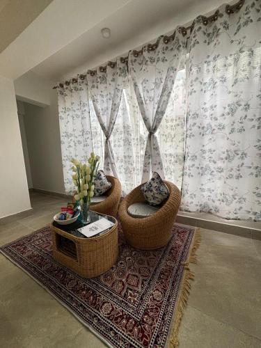 a living room with two chairs and a rug at Arcane viewfinder homestay in Gangtok