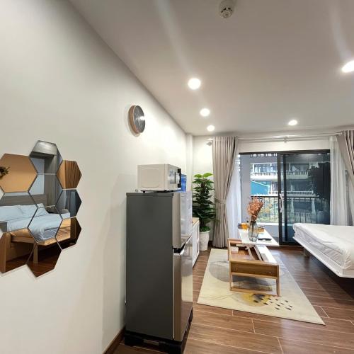 a living room with a bedroom and a bed and a kitchen at The Literature'N Central Hotel and Travel Ha Noi 177 in Hanoi
