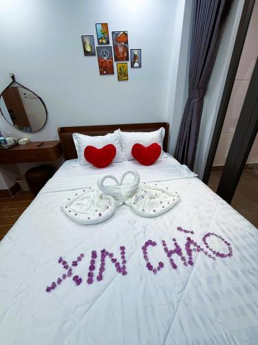 a bed with two hearts and the words my one at Suka Hotel in Tây Ninh
