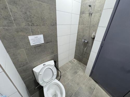 a bathroom with a toilet and a shower at Podium Home2 for 7pax at AEON Mall Kuching in Kuching