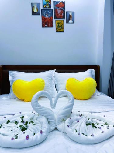 two swans made out of towels on a bed at Suka Hotel in Tây Ninh
