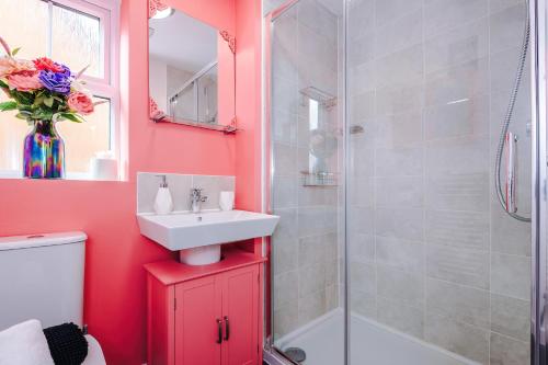 a bathroom with a sink and a shower at Vibrant Home in Crewe by 53 Degrees Property, Ideal for Business, FREE Parking! in Crewe