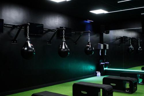 a black room with severaloons hanging on a wall at Village Hotel Wirral in Bromborough