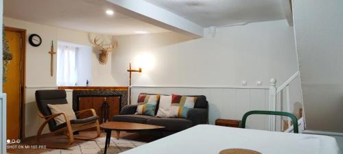 a living room with a couch and a chair at Los Callejos - Casita for 4 people - 3 bedrooms in Los Callejos