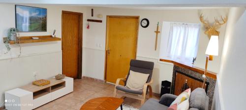 a living room with a couch and a fireplace at Los Callejos - Casita for 4 people - 3 bedrooms in Los Callejos