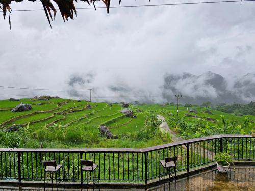 a group of chairs sitting on top of a hill at Pu Luong Serenity Lodge in Pu Luong