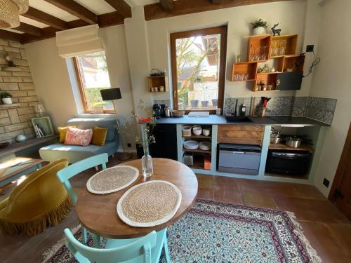 une cuisine avec une table et des chaises dans une pièce dans l'établissement Le refuge du Cèdre, à Belfort