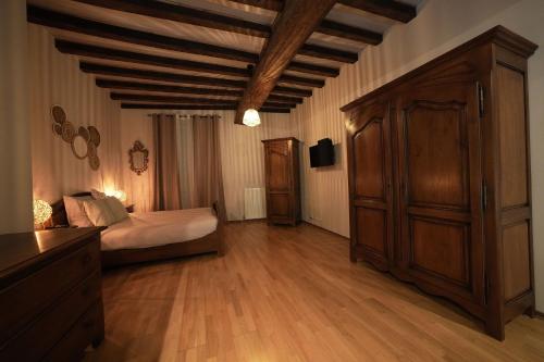 a bedroom with a bed and a dresser at gîte Chez Joëlle in Les Riceys