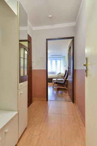 a hallway with a door leading to a living room at Leśna Przystań in Rewal