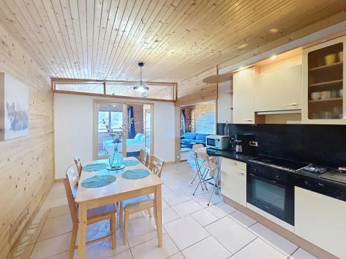 une cuisine et une salle à manger avec une table et des chaises dans l'établissement La Tanière : 4 personnes, à Gérardmer