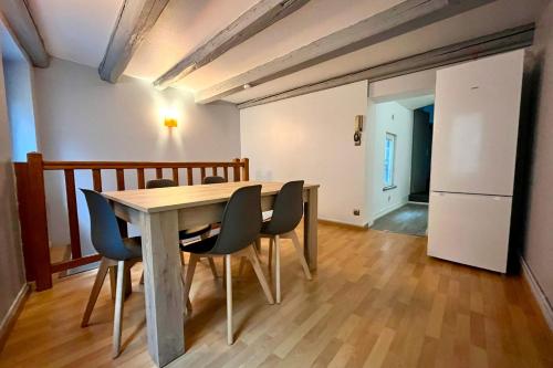 a dining room with a wooden table and chairs at Nancy Vieille ville Le Duplex de St Epvre in Nancy