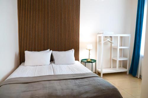 a bedroom with a large bed with two pillows at Kaunas Old Town Apartment in Kaunas