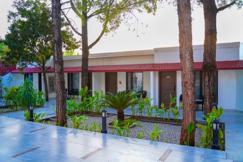 a building with trees in front of it at IFQ Hotel & Resort Islamabad in Islamabad